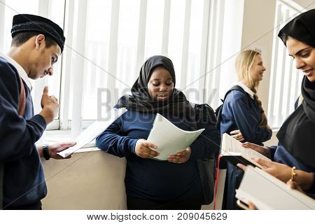 Diverse Muslim children studying in classroom