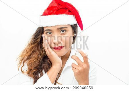 Face of confident young Asian businesswoman wearing Santa hat holding champagne flute and looking at camera. Christmas and office party concept