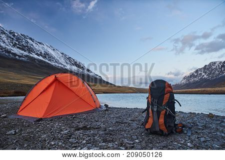 Campsite and Tent with Snow-capped peaks in the Mountains