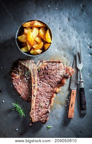 Tbone Steak And Chips With Herbs And Salt
