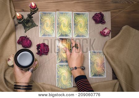Tarot cards on wooden desk table of fortune teller. Tarot reading.