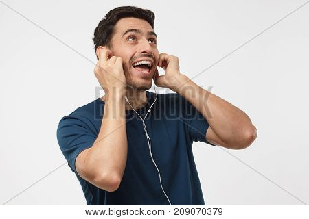 Close Up Shot Of Attractive Young Guy Singing His Favourite Song Loudly, Listening Cool Track, Feeli