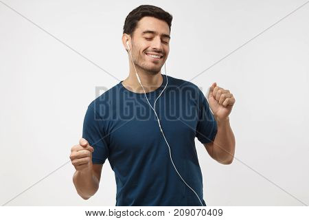 Catch The Rythm. Feel Th Vibe. Young Handsome Man With Beautiful Smile, In Blue T-shirt, Dancing, Li
