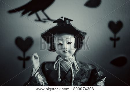 Japanese doll face fear in dark Background.