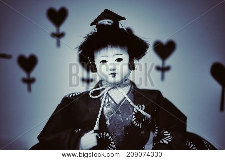Japanese doll face fear in dark Background.