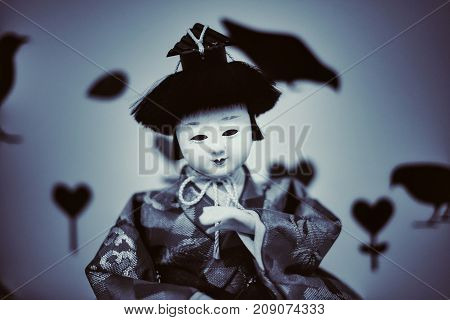 Japanese doll face fear in dark Background.
