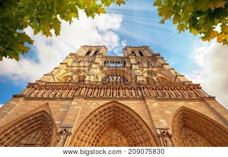 Notre-dame Cathedral In Paris France With Golden Light Rays.