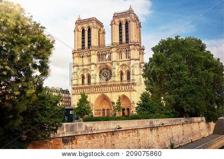 Notre-dame Cathedral In Paris France With Golden Light Rays.