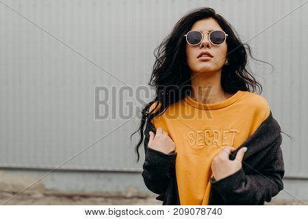 Portrait Of Stylish Modern Young Curly Woman In Coat Sunglasses