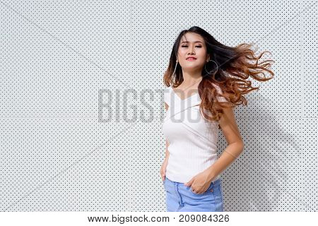 Beautiful young asian woman fashion white shirt with skirt jeans denim hipster portrait on modern black and white background outdoor Copy space the left