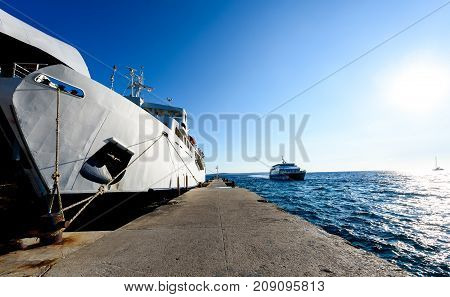 Front Loading Ferry Boat Moored With Lifted Bow At Pier.