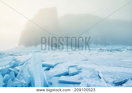 Field of blue ice and rocks Hoboy with sun. Russia. Lake Baikal