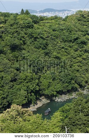 Kyoto, Japan - May 20, 2017: A wooden boat on the Katsura River at Otsuki, Yamanashi, Japan seen from the Senko-ji, a 400-year-old temple