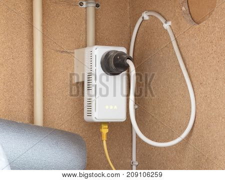 Powerline Network Adaper Plugged Into A Wall Socket