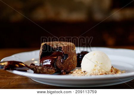 chocolate Fondan with syrup and ice-cream on a plate