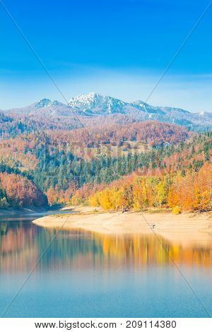 Panoramic view of Lokvarsko lake with Risnjak mountain in background, beautiful colorful mountain autumn landscape, Lokve, Gorski kotar, Croatia