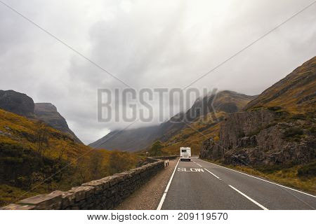 RV pick-up truck and trailer climbing scenic mountain road in the Badlands