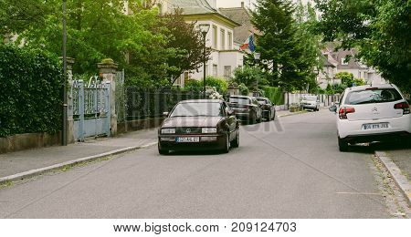STRASBOURG FRANCE - JUN 25 2017: Vintage Volkswagen Scirocco coupe driving through an upper-class neighbourhood in Strasbourg France