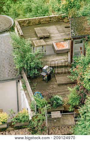 View on a rooftop wood terrasse with a barbecue grill in downtown Luxembourg in early spring