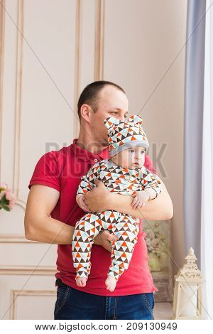Adorable Caucasian baby and his father. Portrait of a three months old baby boy.