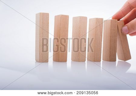 Hand Holding Wooden Domino