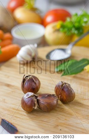 Sweet roated chestnuts on brown wooden board at kitchen.