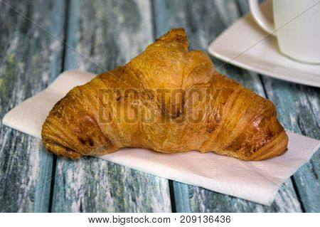 Traditional French butcher croissant on table. Typical european bakery - rogal francuski.