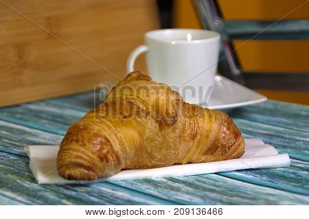 Traditional French butcher croissant on table. Typical european bakery - rogal francuski.
