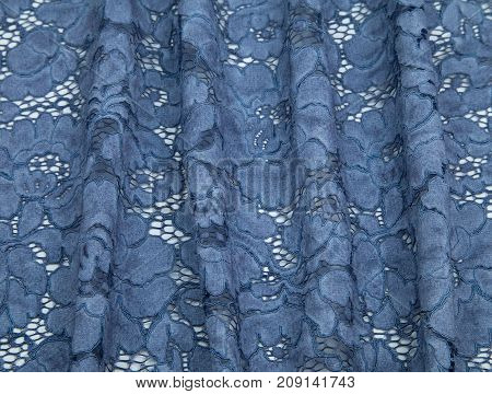 pale blue, blue guipure folds laid out on a white table