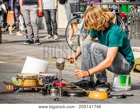 percussionist use pots and pans to play drums - busker street artist musician