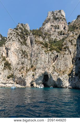 CAPRI ITALY - JUNE 13 2017: Boats with tourists near Grotta Bianca and Grotta Meravigliosa Capri Italy