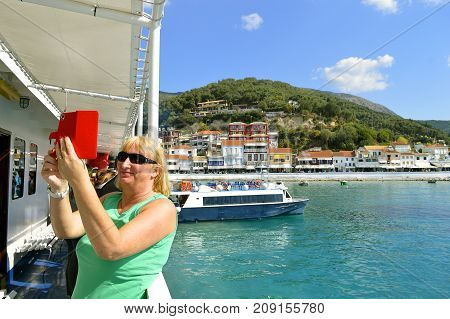 Paxos Corfu Greece - October 1 2017 : Lady taking a selfie in Paxos harbour