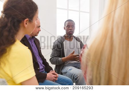 Meeting of support group. African-american man talking about his life, telling his problems and issues. Mental health, psychotherapy concept