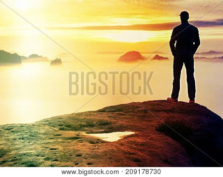Hiker Watching To Autumn  Sun At Horizon . Beautiful Moment The Miracle Of Nature. Colorful Mist In