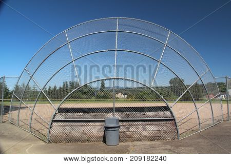 Unused symmetrical baseball backstop during summer break.