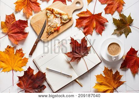Autumn breakfast with coffee, pizza and diary.