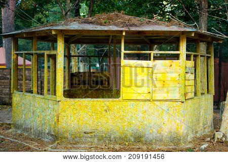 Old wooden ruined house is yellow. Rural abandoned hut. Abandoned house.