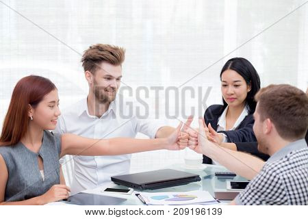 Portrait of happy business partners with smiles and geture of teamwork.