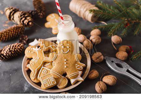 Milk and cookies. Gingerbread cookies on a gray background. Christmas cookies. Ginger men