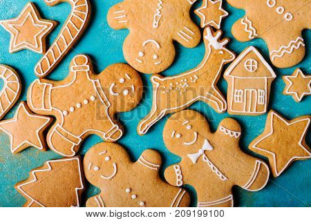 Ginger men with colored glaze on a turquoise background .. Gingerbread. Christmas cookies. Ginger man in a colored sweater.