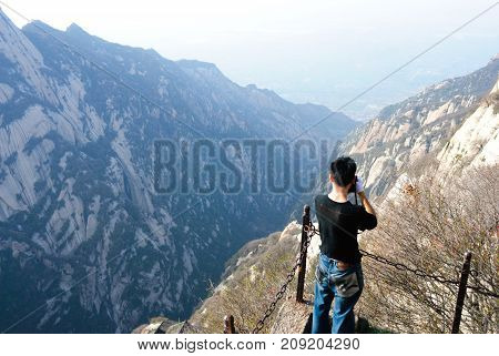 Man standing in front of Huashan mountain view in China