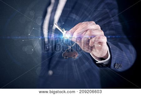 Businessman in suit holding over a key with connection concept around