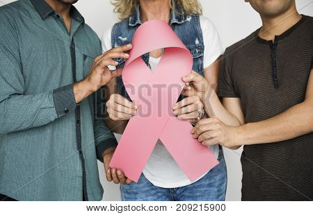 people holding ribbin symbol banner