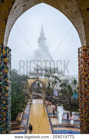 Phetchabun Thailand - August 6 2017: Buddhist tourists sightseeing beautiful white five Buddha Images at Phasornkaew Buddhist temple in Phetchabun Thailand