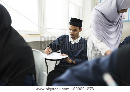 diverse muslim children studying in classroom