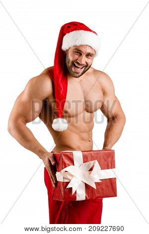New year fitness strong and masculine torso man wearing Santa Claus hat with muscular body and big gift box on studio with white background