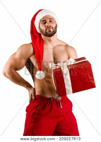 Fitness man wearing Santa Claus hat with muschular body and big new year gift on studio with white backgroung