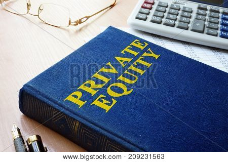 Book with title private equity and calculator.