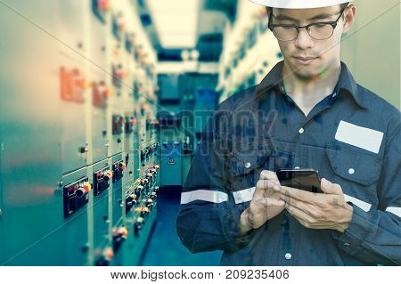 Double exposure of Engineer or Technician man using smart phone for control electric in switch gear electrical room of oil and gas platform or plant industrial for monitor process business and industry concept.
