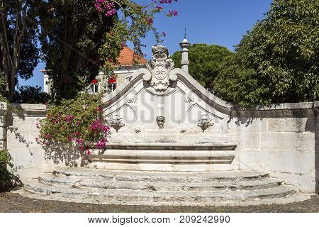 View of the eighteenth century fountain with three spouts and the coat of arms of the Marquis of Pombal in Oeiras Portugal